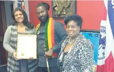  ??  ?? Reggae artiste Ras Emmanuel (centre) receives his proclamati­on from the Essex County Freeholder president Britnee Timberlake (left) and Lady Ira (right), president of the Guyana American Heritage Foundation.