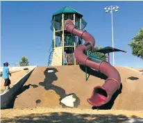  ?? SAMI EDGE/THE NEW MEXICAN ?? The tall, winding slide is one of the main attraction­s at Ragle Park. A large tear mars the matting next to the slide, like a massive black-and-white stain, but many consider it the best playground structure in town.