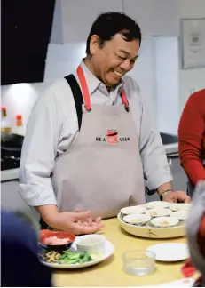  ??  ?? Kei Lum Chan during the cookery class at the School of Wok.