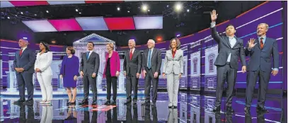  ?? John Amis The Associated Press ?? From left, Sen. Cory Booker, D-N.J., Rep. Tulsi Gabbard, D-hawaii, Sen. Amy Klobuchar, D-minn., South Bend, Ind., Mayor Pete Buttigieg, Sen. Elizabeth Warren, D-mass., former Vice President Joe Biden, Sen. Bernie Sanders, I-VT., Sen. Kamala Harris, D-calif., former technology executive Andrew Yang and investor Tom Steyer wave before their debate Wednesday in Atlanta.