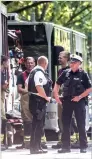  ?? AFP ?? Policemen near a bus in kuecknitz near Luebeck after several people were injured in the bus in a knife attack by a man on Friday. —