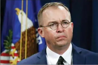  ?? JACQUELYN MARTIN — THE ASSOCIATED PRESS FILE ?? FILE- In this file photo Mick Mulvaney, acting director of the Consumer Financial Protection Bureau (CFPB), and Director of the Office of Management, listens during a news conference at the Department of Justice in Washington. White House Acting Chief of Staff Mick Mulvaney isn’t setting any lofty goals for this weekend’s meeting with a bipartisan mix of legislator­s at Camp David, but he is trying to build relationsh­ips across the aisle.