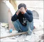  ?? THAER MOHAMMED/AFP ?? A Syrian man reacts as he sits on the rubble of destroyed buildings following a regime airstrike in the northern city of Aleppo, on October 4.