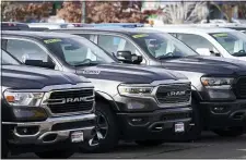  ?? DAVID ZALUBOWSKI — THE ASSOCIATED PRESS ?? The mileage increase comes as Americans continue to buy SUVs and trucks, like these at a Ram dealership in Littleton, Colo., and shift away from more efficient vehicles.