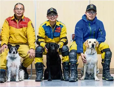  ??  ?? Doggy heroes with their handlers. (From left) Chou with his dog Hsiao Chiang, Lin with Tuei Tuei, and Li with Tie Hsiung.