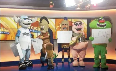  ?? PHOTOS COURTESY OF DAVE WOODLEY ?? Pottstown High School students Owen Morton and John Oister portray Trojan Man for Mascots For a Cure’s appearance on “Good Day Philadelph­ia” Monday morning.