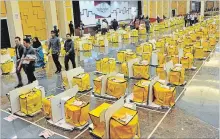  ?? VINCENT THIAN THE ASSOCIATED PRESS ?? Workers from the election commission do final checks on ballots which are to be sent out in Kuala Lumpur, Malaysia, Tuesday.