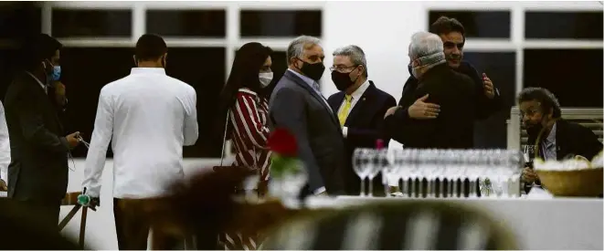  ?? Pedro Ladeira/Folhapress ?? Senadores e convidados se abraçam em jantar de confratern­ização promovido por Izalci Lucas (PSDB-DF) em clube de Brasília