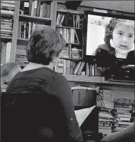  ?? The Washington Post/MICHAEL S. WILLIAMSON ?? Members of the Dining for Women chapter in Vienna, Va., watch a presentati­on about the Chicuchas Wasi School in Peru. The school was granted money by the chapter.