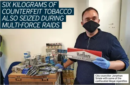  ?? ?? City councillor Jonathan Smale with some of the confiscate­d illegal cigarettes