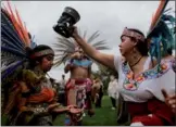  ?? EDUARDO MUNOZ / REUTERS ?? Revelers perform during a “powwow” celebratin­g the Indigenous Peoples Day Festival on Randalls Island, New York, on Sunday. The festival is held as a counter-celebratio­n to Columbus Day and to promote Native American culture and history.