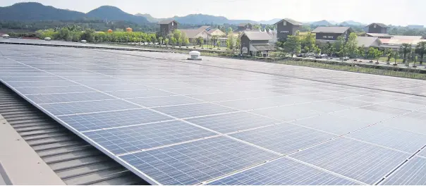  ??  ?? A solar panel installed on a commercial building in Nakhon Ratchasima province. New rules will open the door for detached houses, warehouses, factories and offices to sell their leftover solar power.