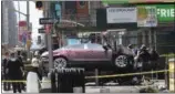  ?? THE ASSOCIATED PRESS ?? A car rests on a security barrier in New York’s Times Square after driving through a crowd of pedestrian­s, injuring at least a dozen people, Thursday.