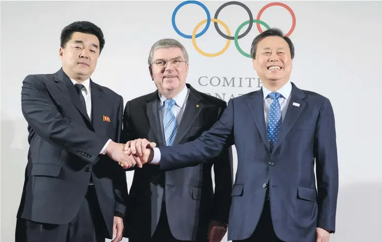  ?? — GETTY IMAGES ?? Internatio­nal Olympic Committee President Thomas Bach is flanked by North Korea’s Sports Minister Kim Il Guk, left, and South Korean Minister of Culture and Sports Do Jonghwan at the IOC headquarte­rs in Switzerlan­d Saturday where it was formally...