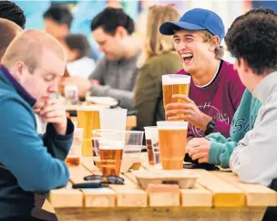  ??  ?? Drinkers in a beer garden in Glasgow as pubs reopened outside in Scotland on Monday