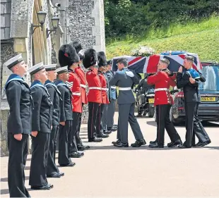  ??  ?? Service personnel carry Dame Vera’s coffin into Brighton Crematoriu­m.