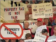  ?? MEDIANEWS GROUP FILE PHOTO ?? Some of the signs carried by angry taxpayers at the a rally in the state Capitol in Harrisburg, calling for the eliminatio­n of school property taxes in Pennsylvan­ia.