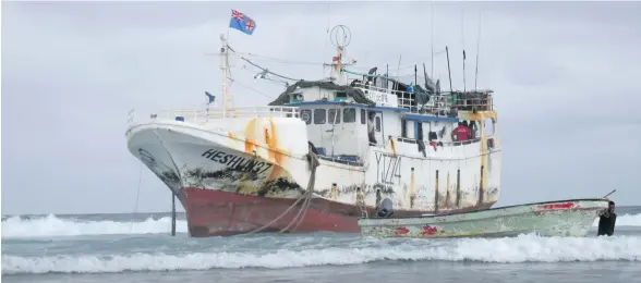  ?? He Shun Photo: Simione Haravanua ?? The that ran aground on the Navakavu Reef near the Bay of Islands in Lami. Crew members start to clear their belongings on September 24, 2018.