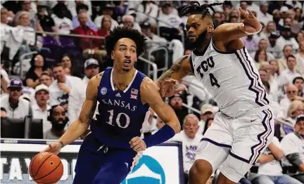  ?? Tony Gutierrez/Associated Press ?? Kansas forward Jalen Wilson (10) works to the basket as TCU’s Eddie Lampkin Jr. defends in the first half on Monday in Fort Worth, Texas.
