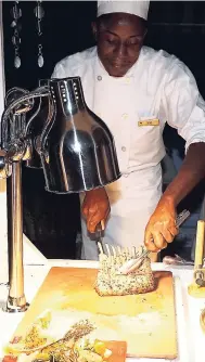  ?? PHOTO BY JANET SILVERA ?? Couples Tower Isle’s Deno Williams pares the grilled lamb rack.