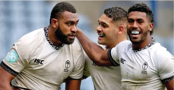  ?? Photo: ANC 2020 ?? Rookie Flying Fijians openside flanker Mesulame Kunavula (left) is congratula­ted by hooker Sam Matavesi and Frank Lomani after scoring a try against Georgia in last November’s Autumn Nations Cup. The three players are expected to play the All Blacks in the two Test series in July.