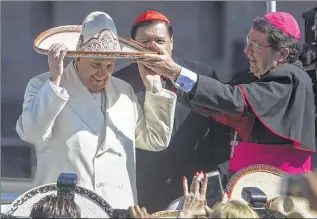  ?? ASSOCIATED PRESS ?? Pope Francis dons a sombrero from a person in the crowd Saturday in Mexico City. With the pope are Cardinal Norberto Rivera (center), the archbishop of Mexico City, and Papal Nuncio Christophe Pierre.