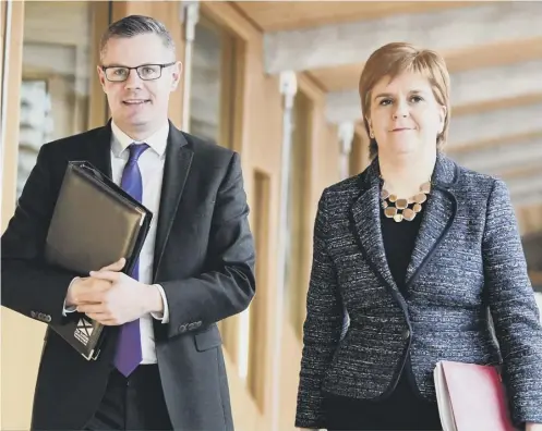  ??  ?? 0 Finance Secretary Derek Mackay and First Minister Nicola Sturgeon arrive at Holyrood ahead of the final debate on the Budget