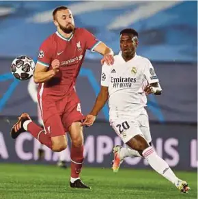  ?? EPA PIC ?? Real Madrid’s Vinicius Junior (right) and Liverpool’s Nathaniel Phillips in action in Thursday’s Champions League quarter-final, first leg at Alfredo Di Stefano Stadium.