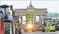  ??  ?? ANNEGRET HILSE/REUTERS Tractors arrive at Brandenbur­g Gate as farmers gather for a demonstrat­ion against the agricultur­al policies of the federal government, in Berlin, Germany, on November 26, 2019.