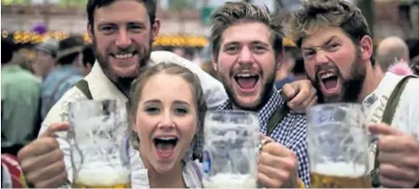  ?? SPECIAL TO POSTMEDIA NEWS ?? Revellers in Munich, Germany, raise their mugs to Oktoberfes­t.