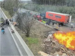  ?? Picture: Christian Levaux/Reuters ?? Farmers in Arendonk, Belgium, use their tractors to block a highway near the border with the Netherland­s this week as they protest over price pressures, taxes and green regulation, grievances shared by farmers across Europe.