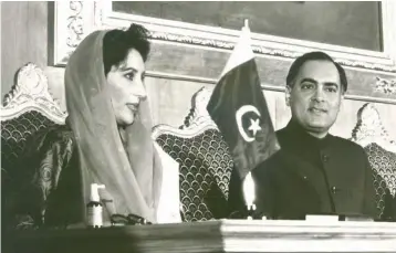  ?? — PTI ?? Rajiv Gandhi with then Pakistan Prime Minister Benazir Bhutto at the inaugural session of the fourth Saarc summit in Islamabad in 1988