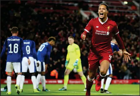  ??  ?? Virgil van Dijk, making his debut for Liverpool after his move from Southampto­n, celebrates after scoring the winning goal in the derby