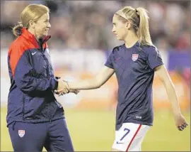  ?? Kent Horner Getty Images ?? JILL ELLIS, with Morgan Brian before an exhibition against China, grew up in a soccer family. Her father worked with national teams in five countries.