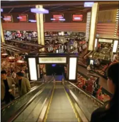  ?? AP Photo ?? In this file photo, taken Wednesday, Nov. 14, 2007, guests descend an escalator to the main casino floor of the Planet Hollywood Resort & Casino in Las Vegas.