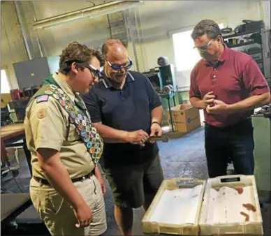  ?? PHOTOS BY JOHN BREWER — ONEIDA DAILY DISPATCH ?? From left, aspiring Eagle Scout Jack McElhenney, of Pennsylvan­ia, and his father Jim McElhenney investigat­e the flatware creation process at Sherrill Manufactur­ing with owner Matt Roberts as a tour guide on Wednesday, June 28.