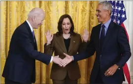  ?? CAROLYN KASTER — THE ASSOCIATED PRESS ?? Vice President Kamala Harris reacts as President Joe Biden shakes hands with former President Barack Obama after Obama jokingly called Biden vice president in the East Room of the White House in Washington on Tuesday.