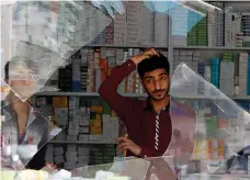  ?? Reuters ?? Kabul shopkeeper surveys the bomb damage to his shop