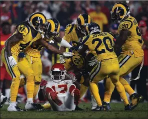  ?? AP/KELVIN KUO ?? Los Angeles Rams players celebrate after cornerback Marcus Peters (22) intercepte­d a pass intended for Kansas City Chiefs wide receiver Chris Conley (17) with 1:18 to play Monday in Los Angeles. The Rams won 54-51 in a game that featured 891 passing yards — 478 by Patrick Mahomes and 413 by Jared Goff.