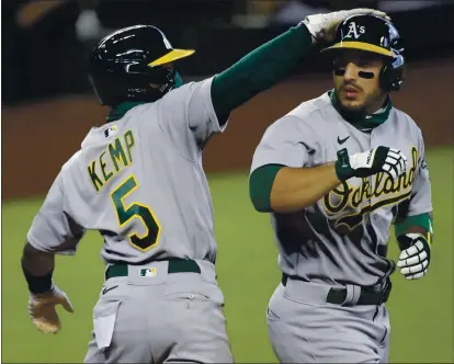  ?? PHOTOS: TED S. WARREN — THE ASSOCIATED PRESS ?? The Athletics’ Ramon Laureano, right, is greeted by Tony Kemp after Laureano hit a three run homer to score Kemp and Marcus Semien.