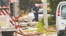  ?? GEOFF ROBINS / THE CANADIAN PRESS ?? Fire officials investigat­e the scene of a house explosion after a car
crashed into a house in London, Ont., on Thursday.