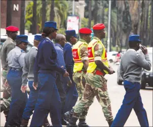  ?? — Picture by Justin Mutenda ?? Zimbabwe Republic Police and members of the Zimbabwe National Army patrol in the Central Business District during a joint operation in Harare yesterday.