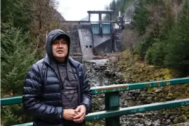  ??  ?? Scott Schuyler stands in front of the Gorge Dam, which diverts the entire Skagit River into a hydroelect­ric tunnel. Photograph: Lester Black