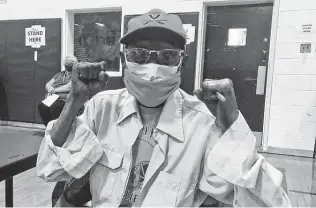  ?? Ben Finley / Associated Press ?? Charles Robbins celebrates getting his second shot of the vaccine on Feb. 27 at Surry County High School in Dendron, Va. Getting vaccinated has been a challenge for rural counties in the U.S.