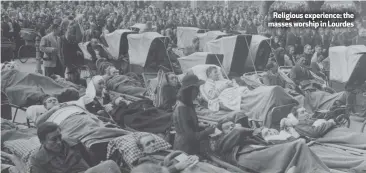  ??  ?? Religious experience: the masses worship in Lourdes