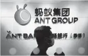  ?? KIN CHEUNG AP ?? An employee walks past a logo of the financial tech company Ant Group at their office in Hong Kong.