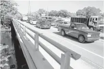  ?? CARLINE JEAN/STAFF PHOTOGRAPH­ER ?? Traffic moves over the 66-year-old Broward Boulevard bridge, which crosses the North Fork of the New River just east of Interstate 95 in Fort Lauderdale. Both spans of the bridge will be rebuilt starting in 2016.