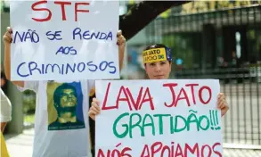  ??  ?? CURITIBA: Demonstrat­ors protest against corruption in front of the Federal Justice Palace in Curitiba, Brazil with signs that read “STF (Supreme Federal Court), don’t give in to the criminals” and “Car Wash, thank you, we support you!” Brazil’s federal...