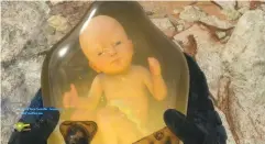  ??  ?? BELOW This is your Bridge Baby, who travels with you in a portable womb and alerts you to imminent peril from BTs. Equal parts cute and creepy, they’ll cry after a fall; rock the controller to pacify them