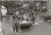  ?? Karen Warren / Houston Chronicle ?? Chris Kendrick with the Precinct 1 Constable’s Office and Bob Wilson and Octavio Gonzalez with Houston SPCA go in search of a stranded cat.